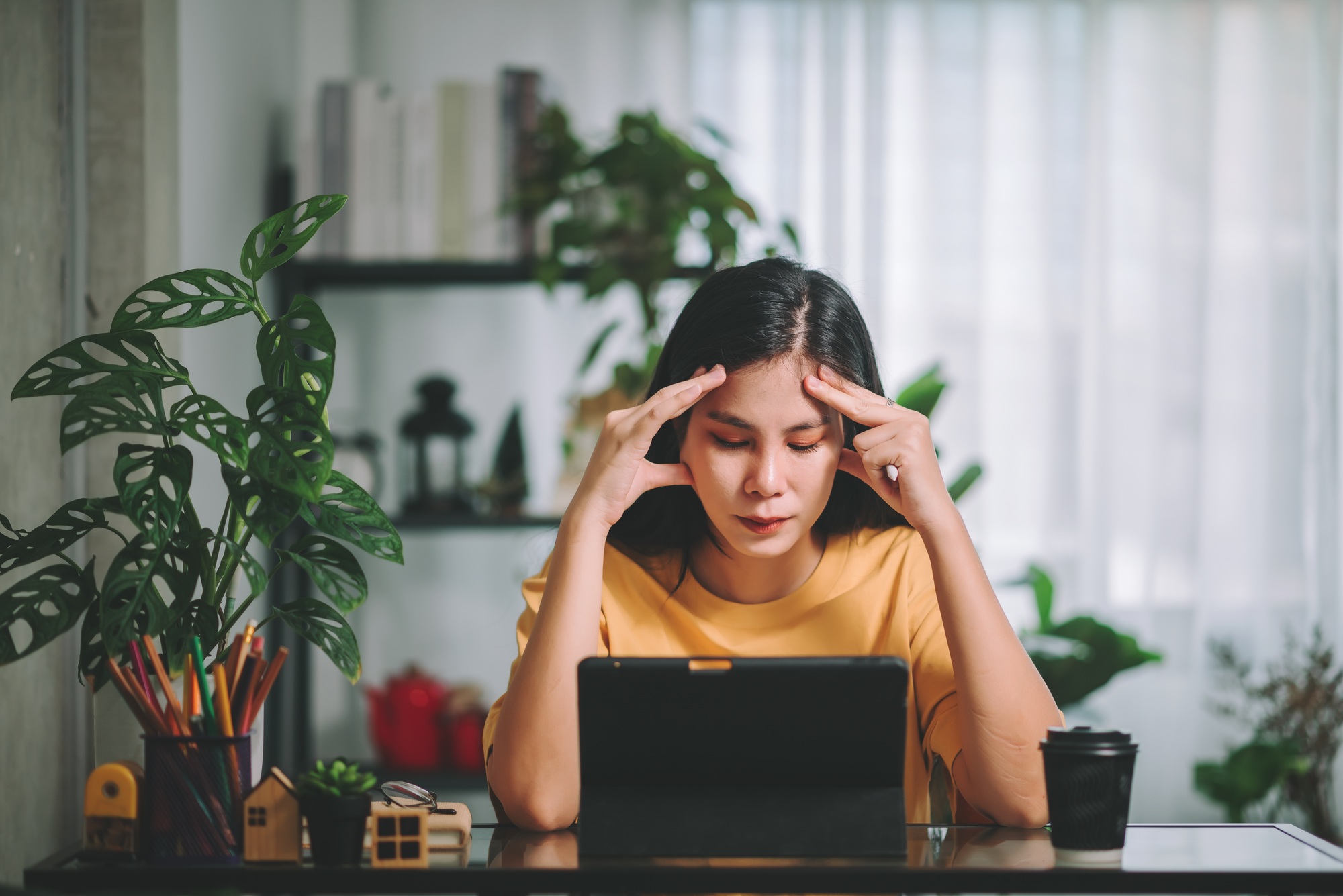 Asian woman has a headache, mental health ,Mental Health Issues