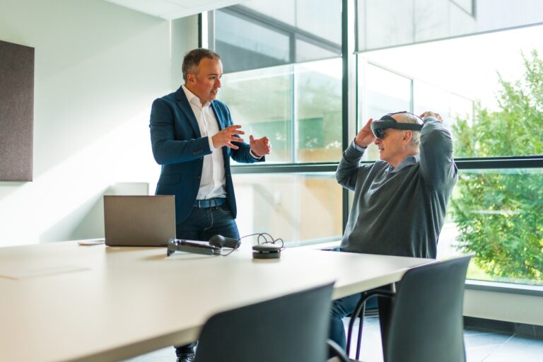 Businessmen during demo of a new mixed vision reality goggles