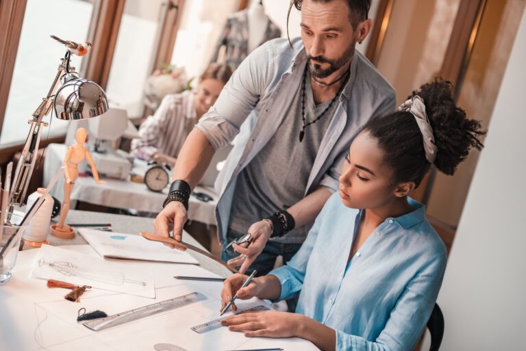 Cropped photo of group of three people at design studio