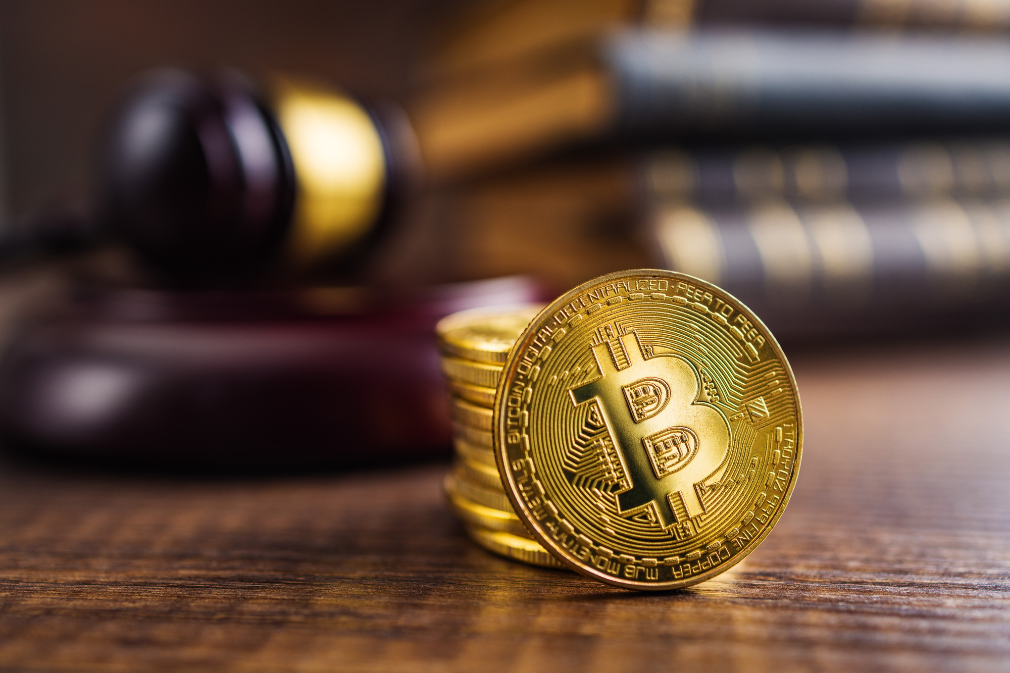 Cryptocurrency. Bitcoin virtual money. Golden coins and judge gavel.