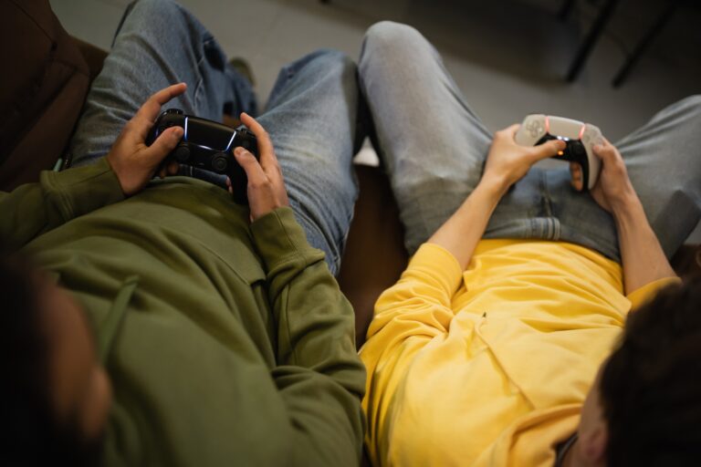 KYIV, UKRAINE - FEBRUARY 13, 2023: Top view of interracial men playing video game in cyber club