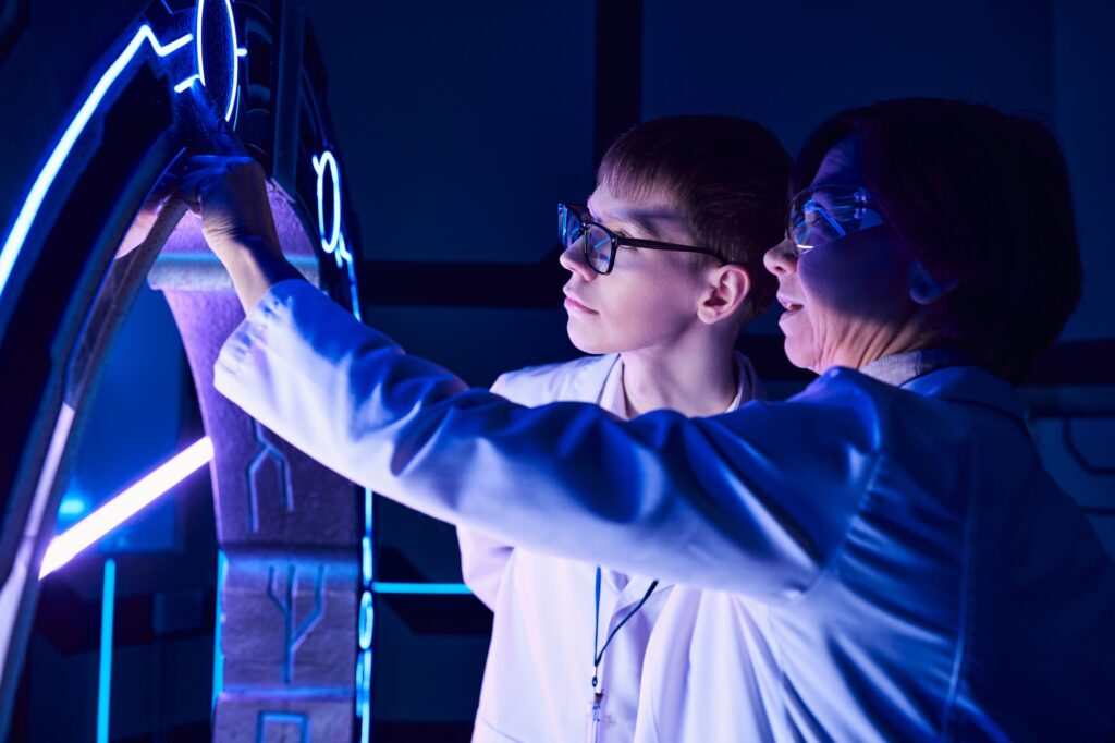 scientific discovery, woman scientist and young intern exploring device in discovery center