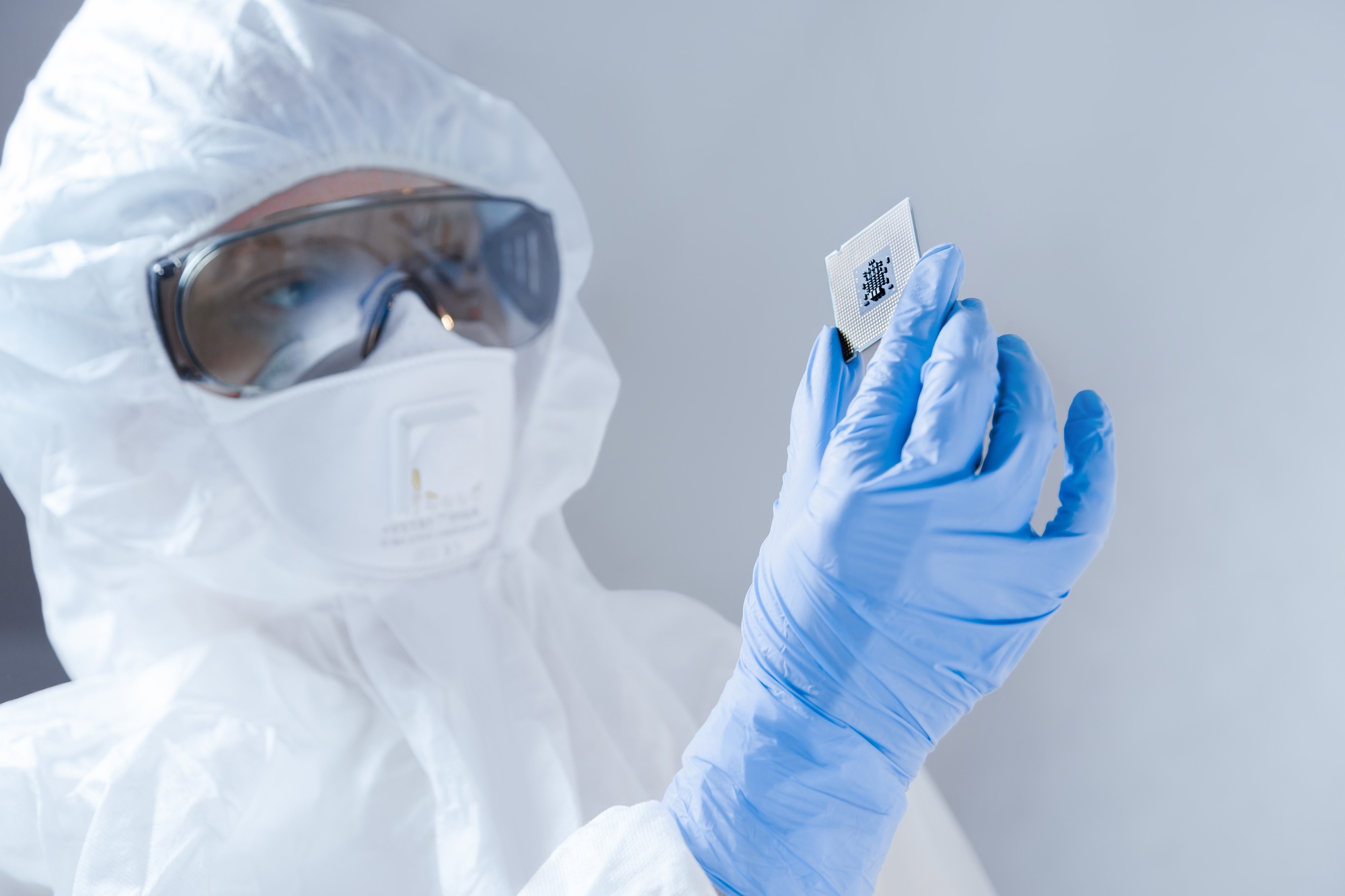 Scientist in laboratory holds new microprocessor