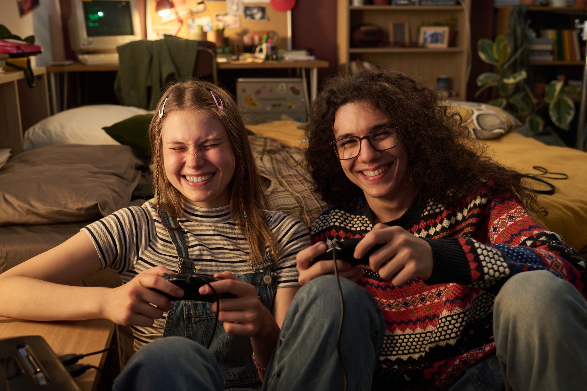 Smiling Teenagers Playing Video Games Together Indoors