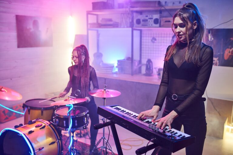 Two girls playing musical instruments in studio