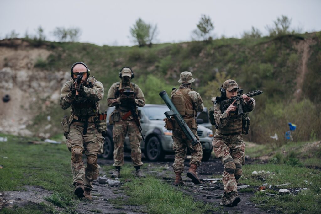 Ukrainian drone operator working covered by soldiers