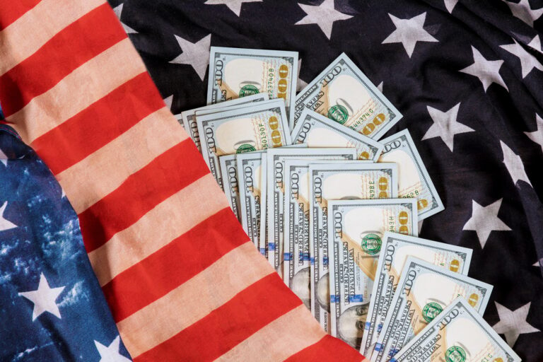 100 american dollars bills on US flag background