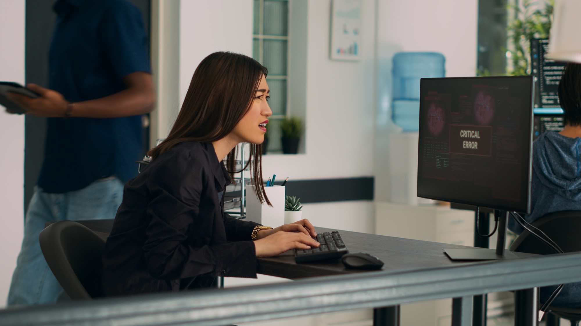 Asian IT engineer encountering system failure error on computer