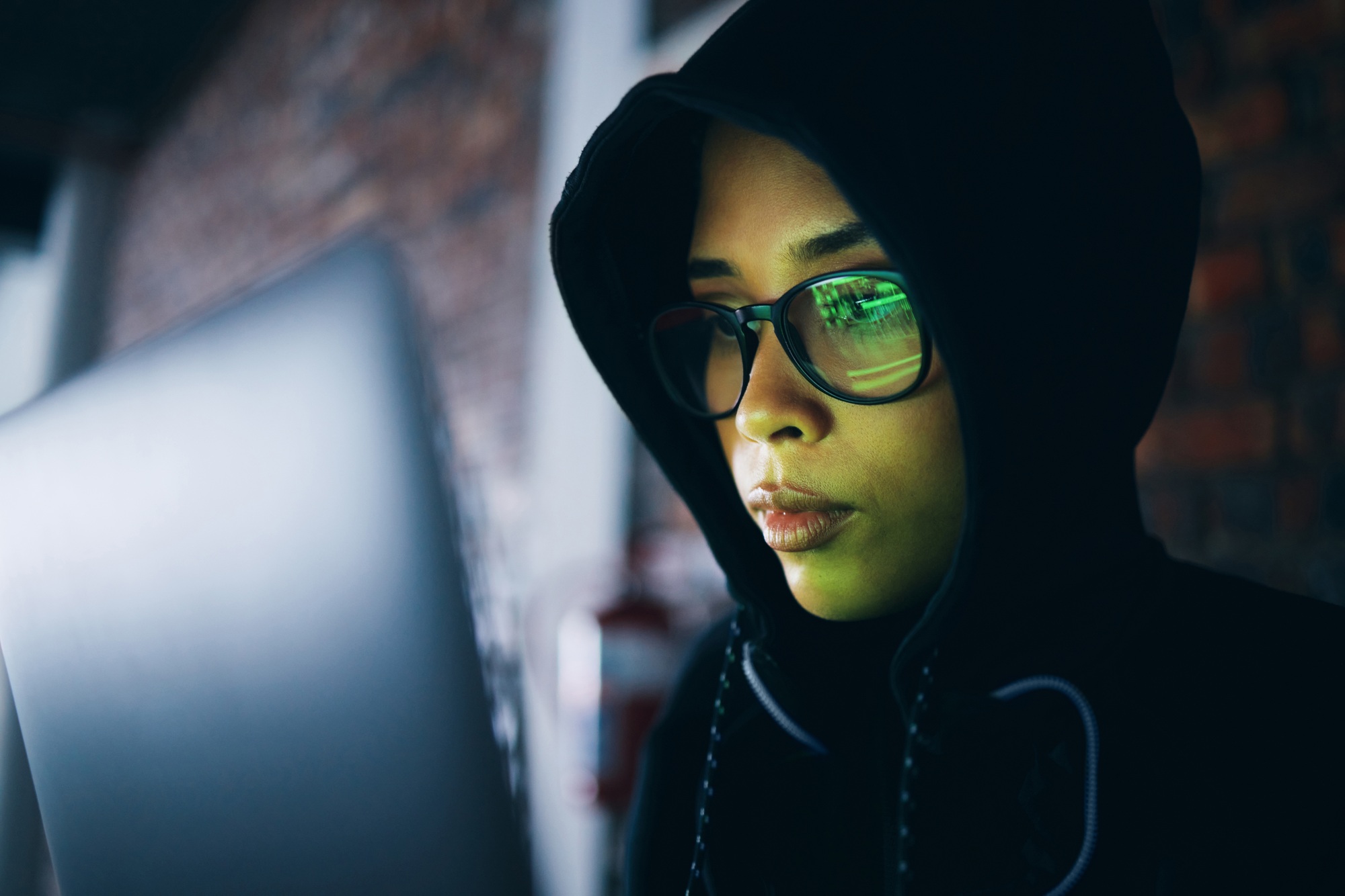 Hacker, woman in dark room with laptop and coding, phishing and cyber crime with IT database or ser