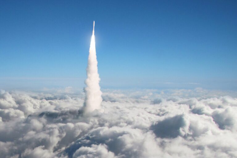 New space rocket takes off through the clouds into space. Spaceship launch