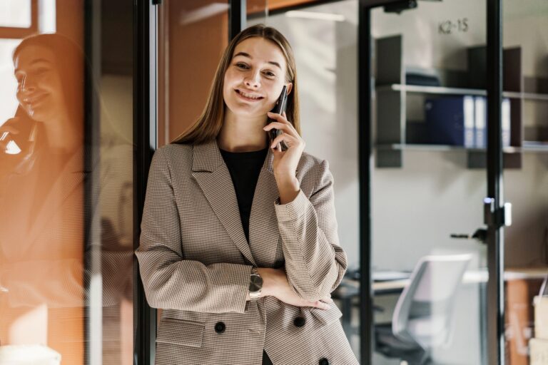 Portrait of a woman smiling emotion a marketing specialist uses a new phone communicates with an AI