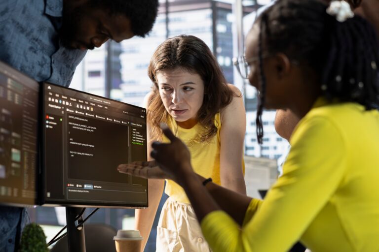 Team of developers talking in office, analyzing complex AI data