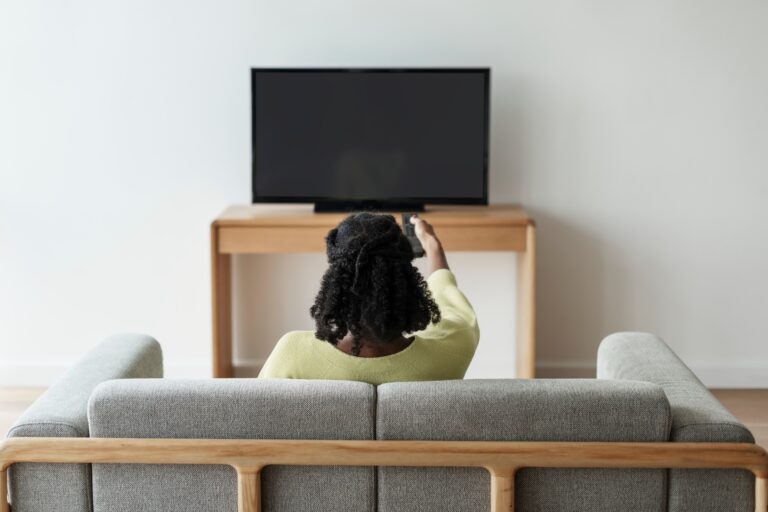 Woman watching TV in her living room