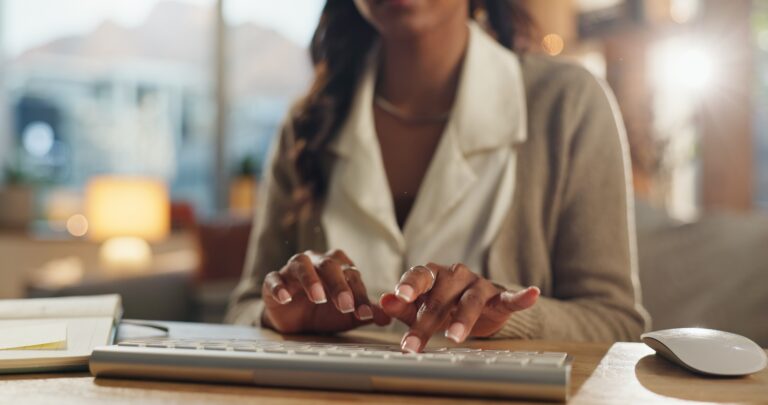 Small business, keyboard or woman hands for typing with notebook, review feedback or brainstorming.