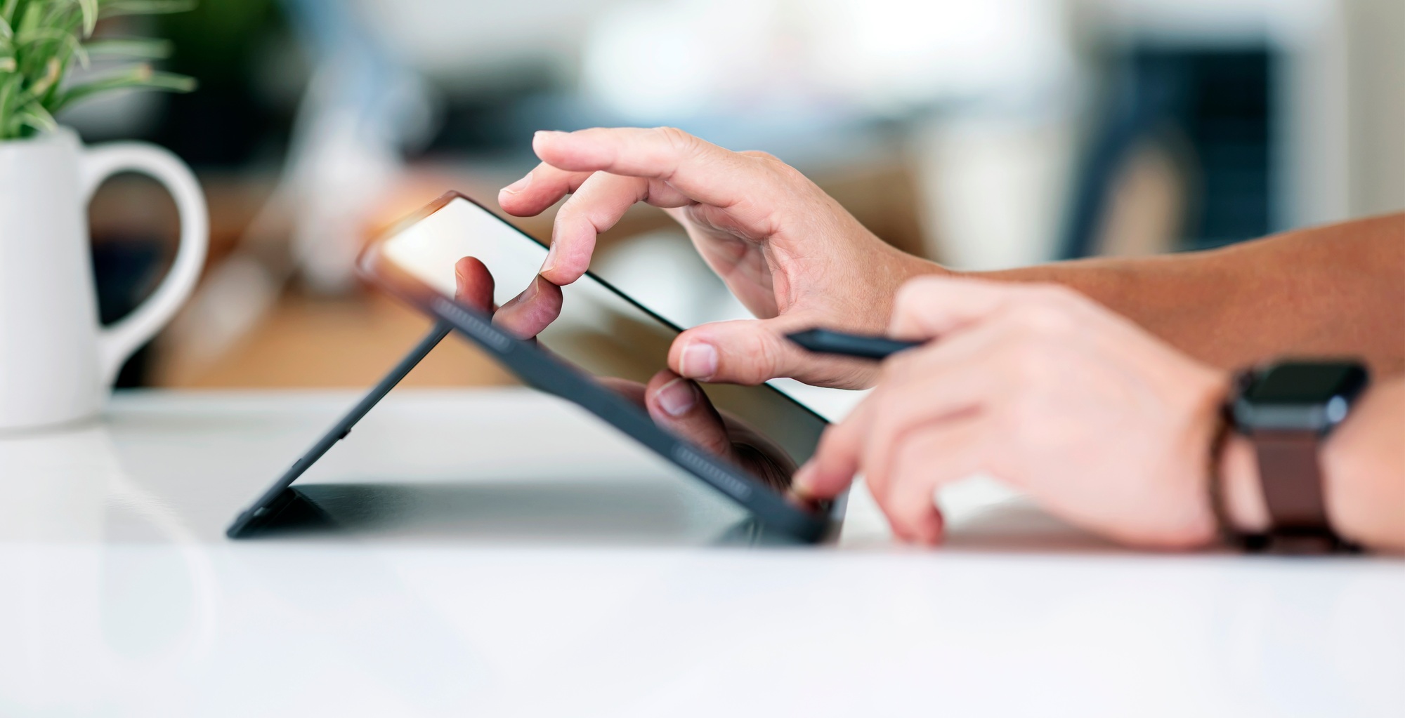 New Frontier in Chatbots Grok AI Redefines the AI Experience close up of businessman's finger touching on digital tablet screen while sitting at hone office.