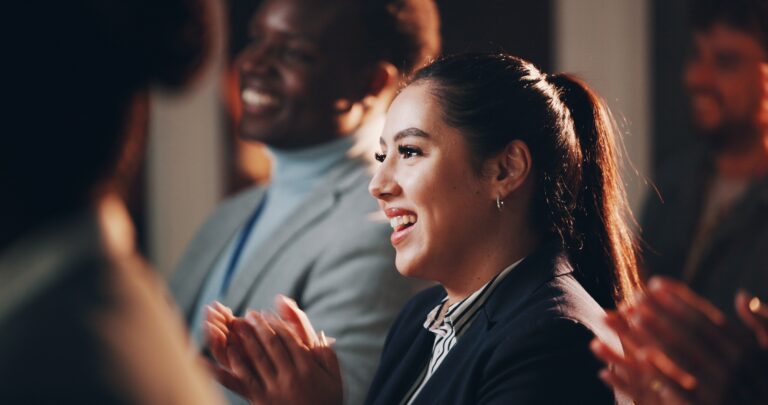 Woman, smile and applause in seminar for business, employee engagement and positive reinforcement.