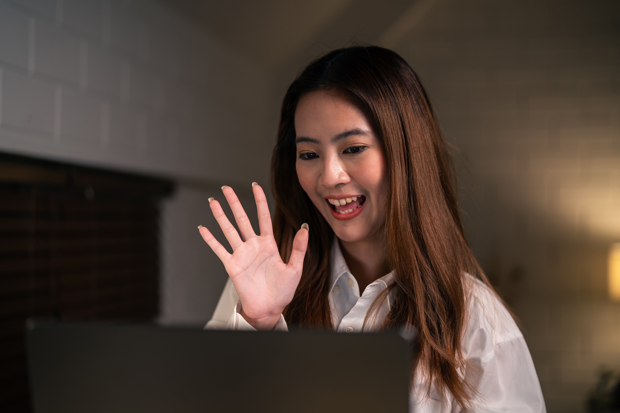 asian young beautiful woman doing remote virtual video call at night.