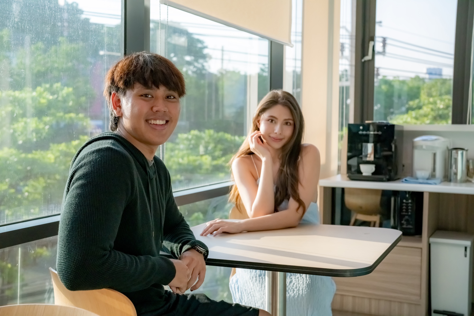 What New AI Chatting Is Really Doing to Teens couple young teen sitting cafe and smile at camera.