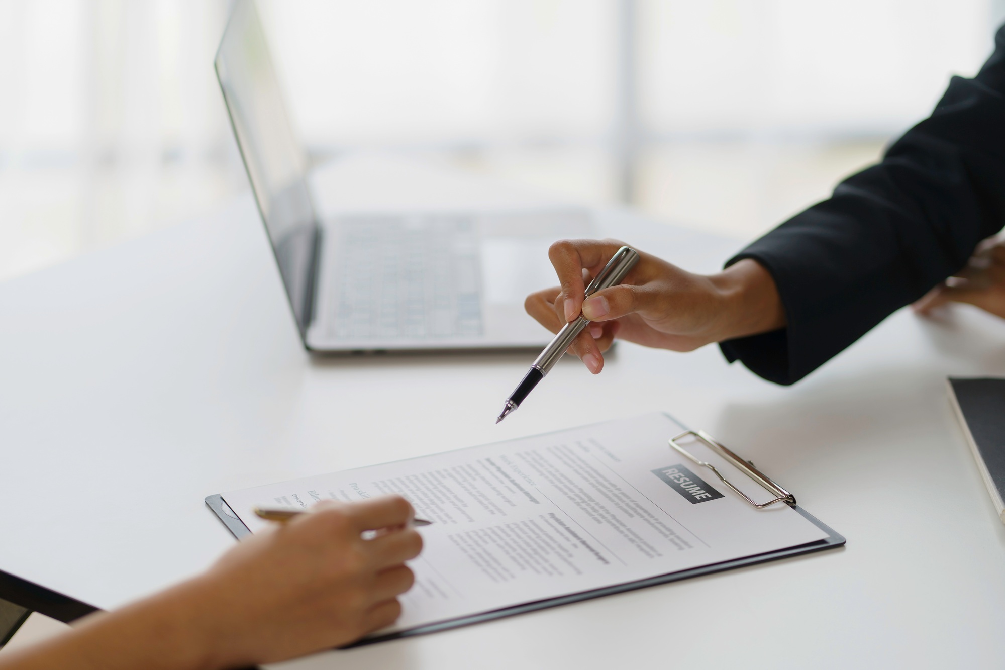 In-Person Interviews Making Comeback in New Age of AI Applications new graduate woman filling out an application form for hr department review