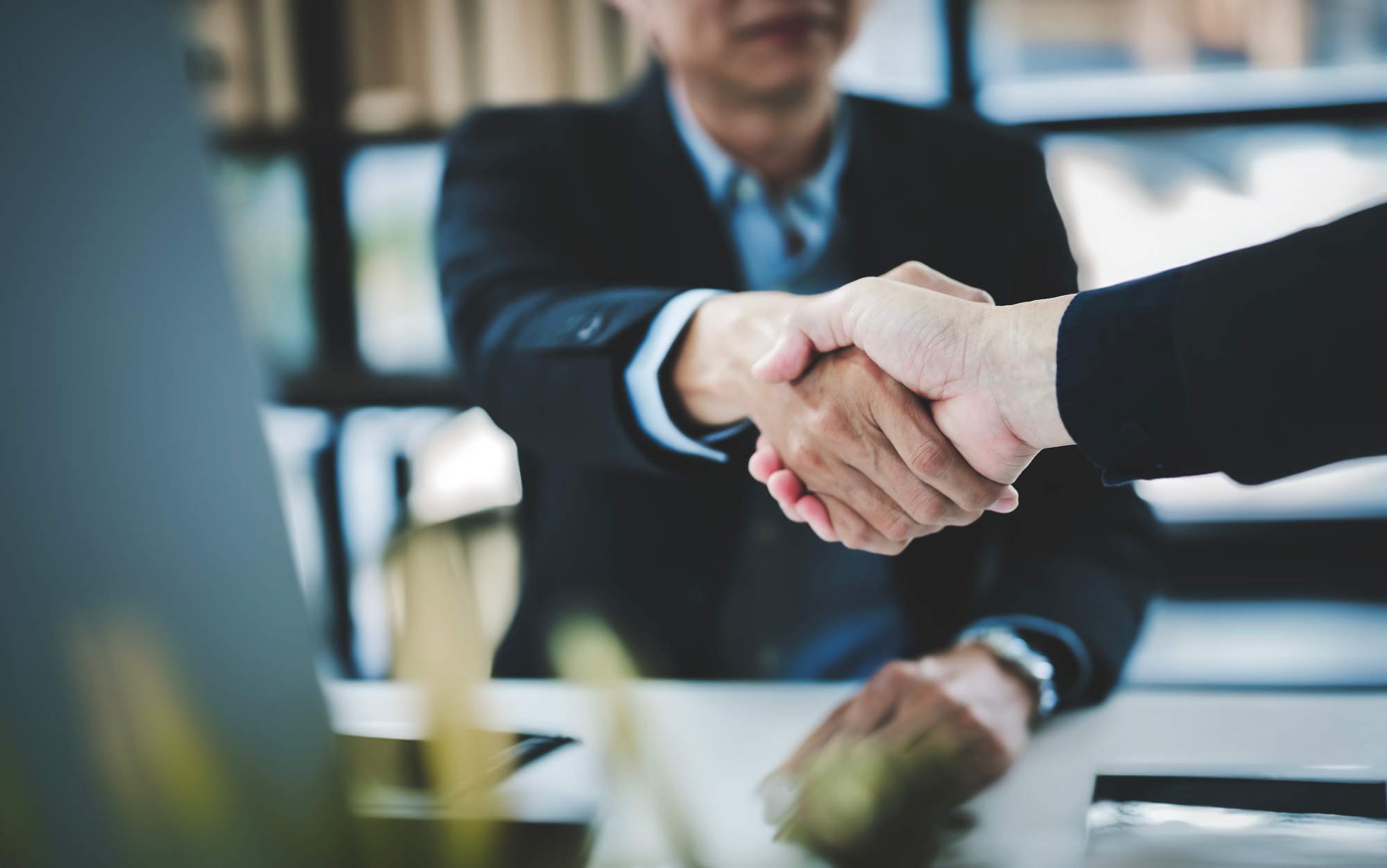 businessman handshake for teamwork of business merger and acquisition,