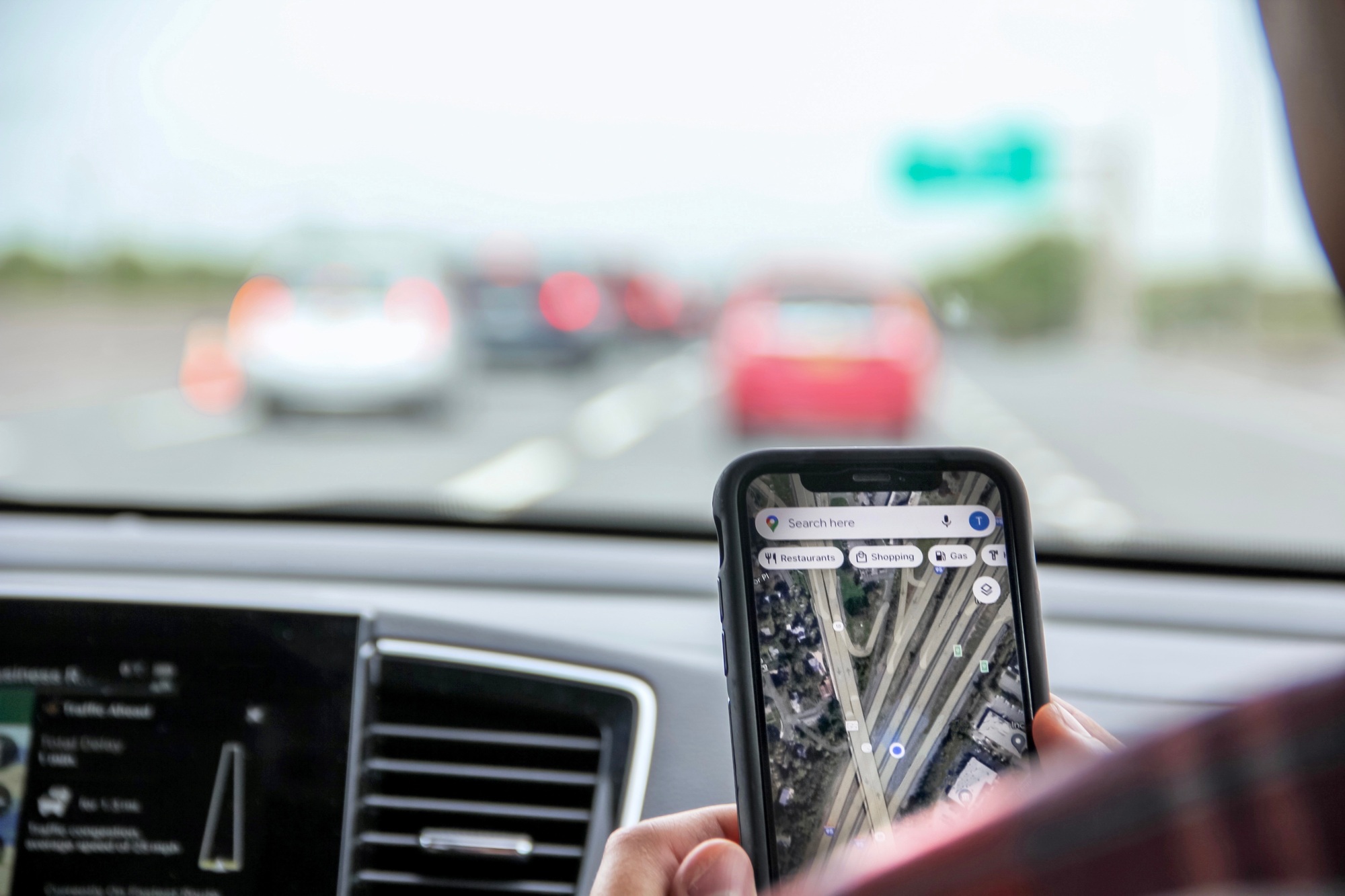 gen z using google map app during road trip in conjunction with vehicle gps for accurate directions