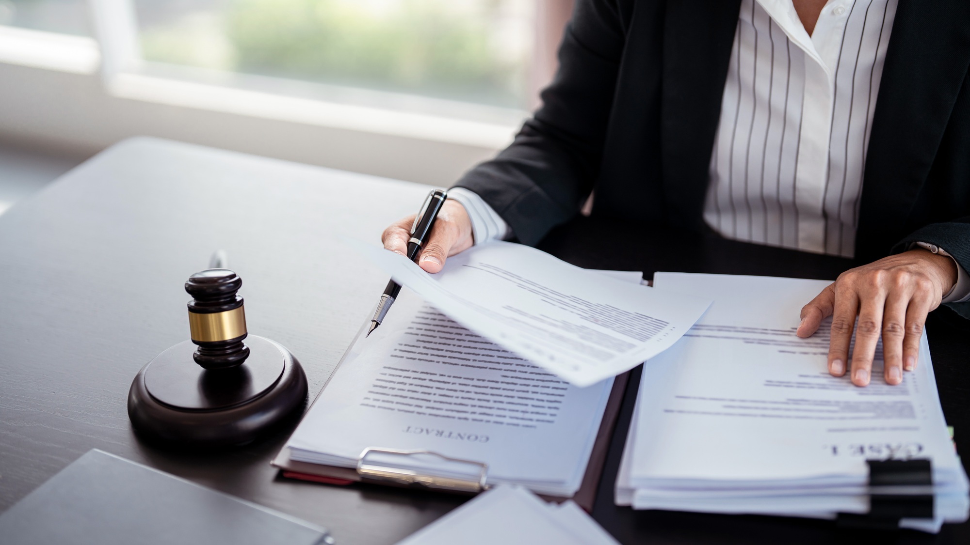 lawyer businesswoman holding document to reading lawsuit and checking about financial