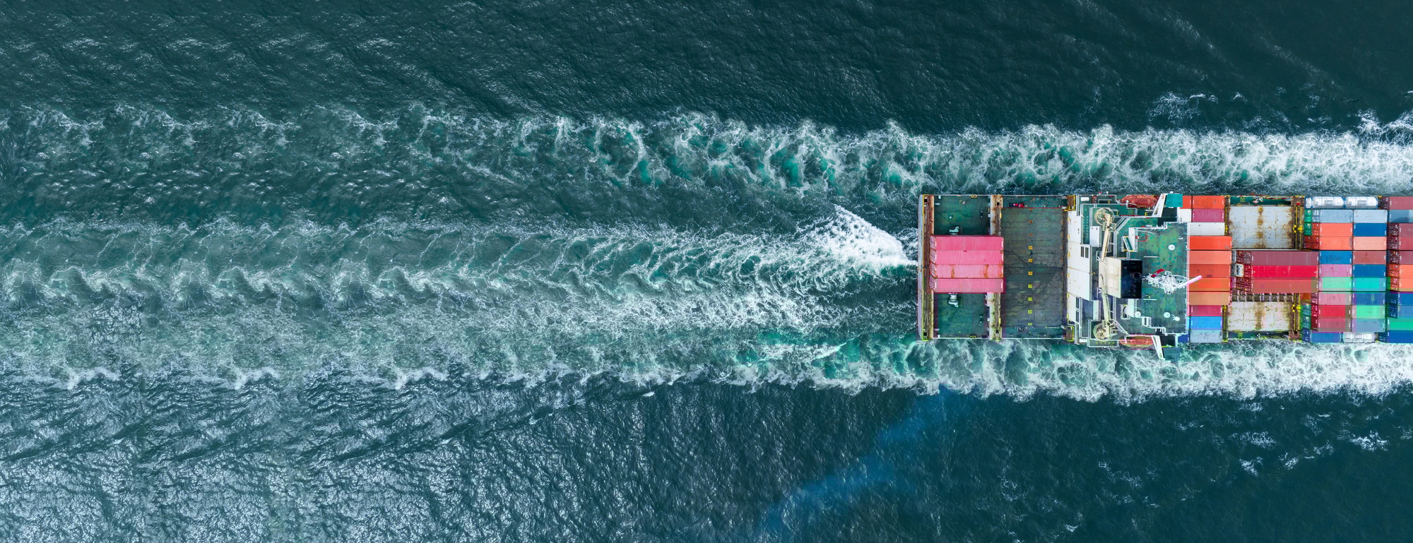 stern of cargo container ship in the ocean sea concept logistic transportation export