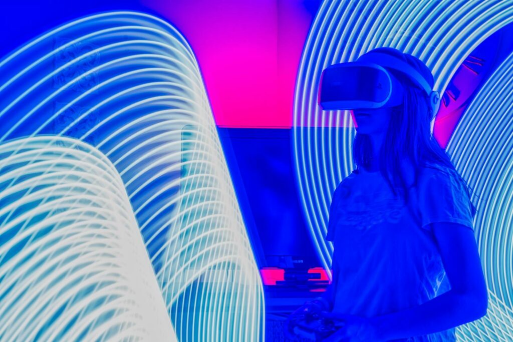 Person immersed in virtual reality with bright neon lights showcasing a futuristic experience.