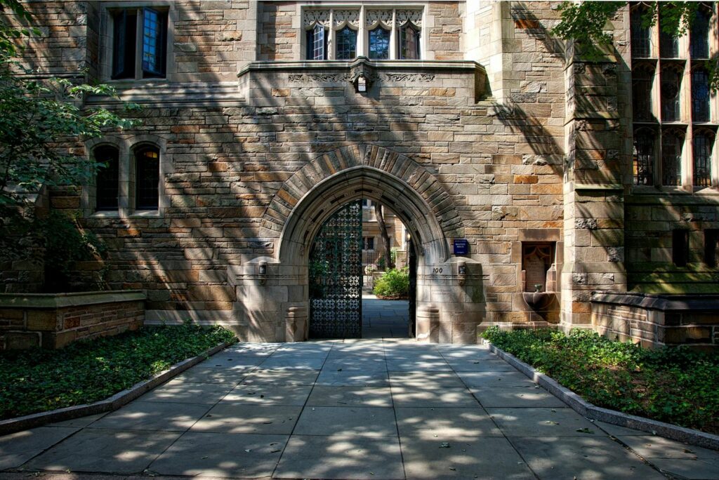Greece Is Teaching New AI to Every Teen the Future Gothic-style stone archway entrance at Yale University campus, surrounded by greenery.