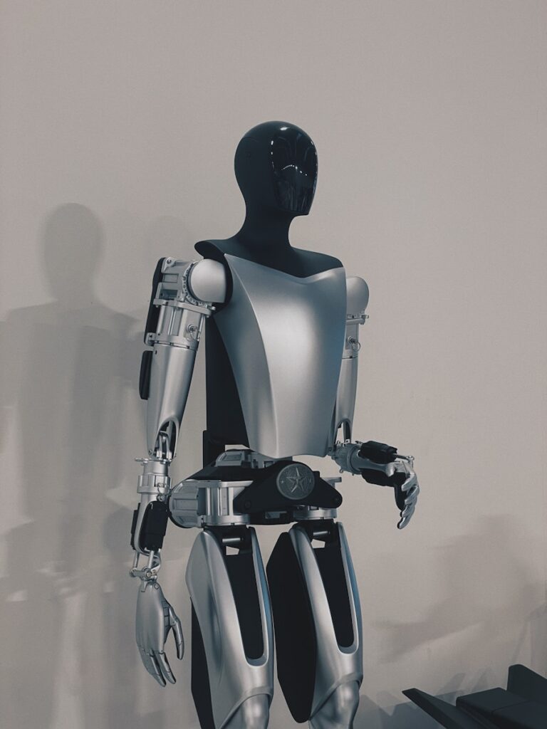 a robot standing in front of a white wall
