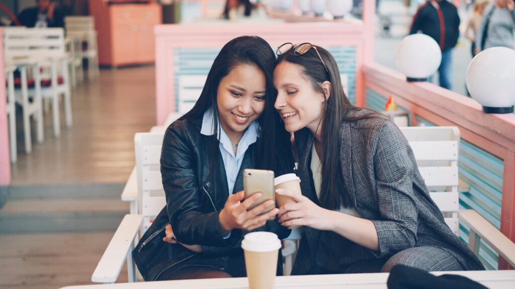 Two women looking at a smartphone together