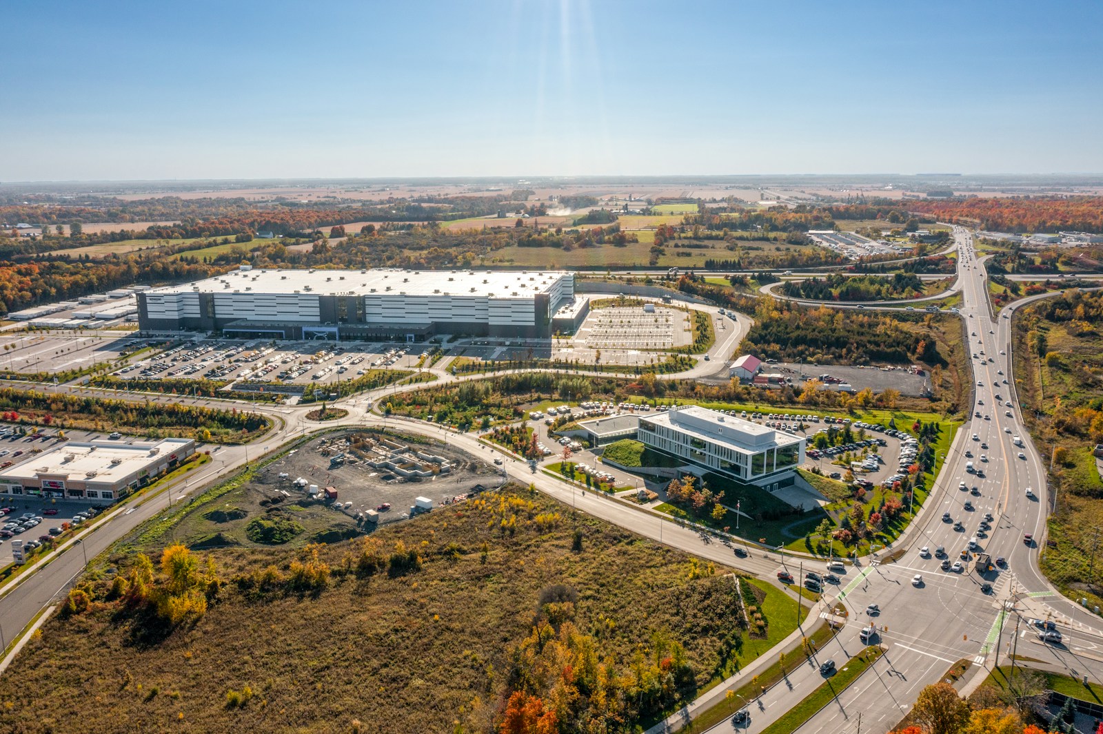 a large building with a road and trees around it