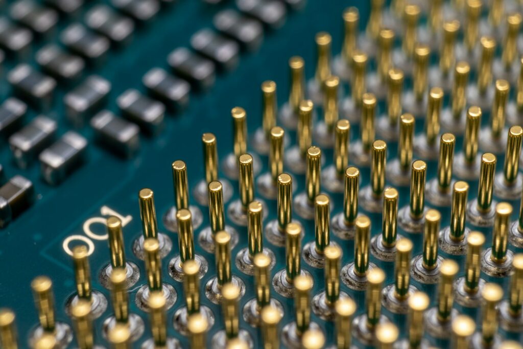 a close up of a computer board with many screws