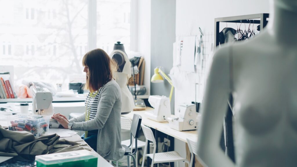A seamstress works on designs in her studio.