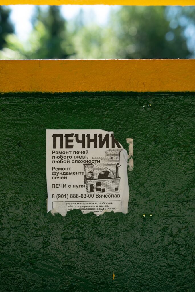 A newspaper on the side of a green wall