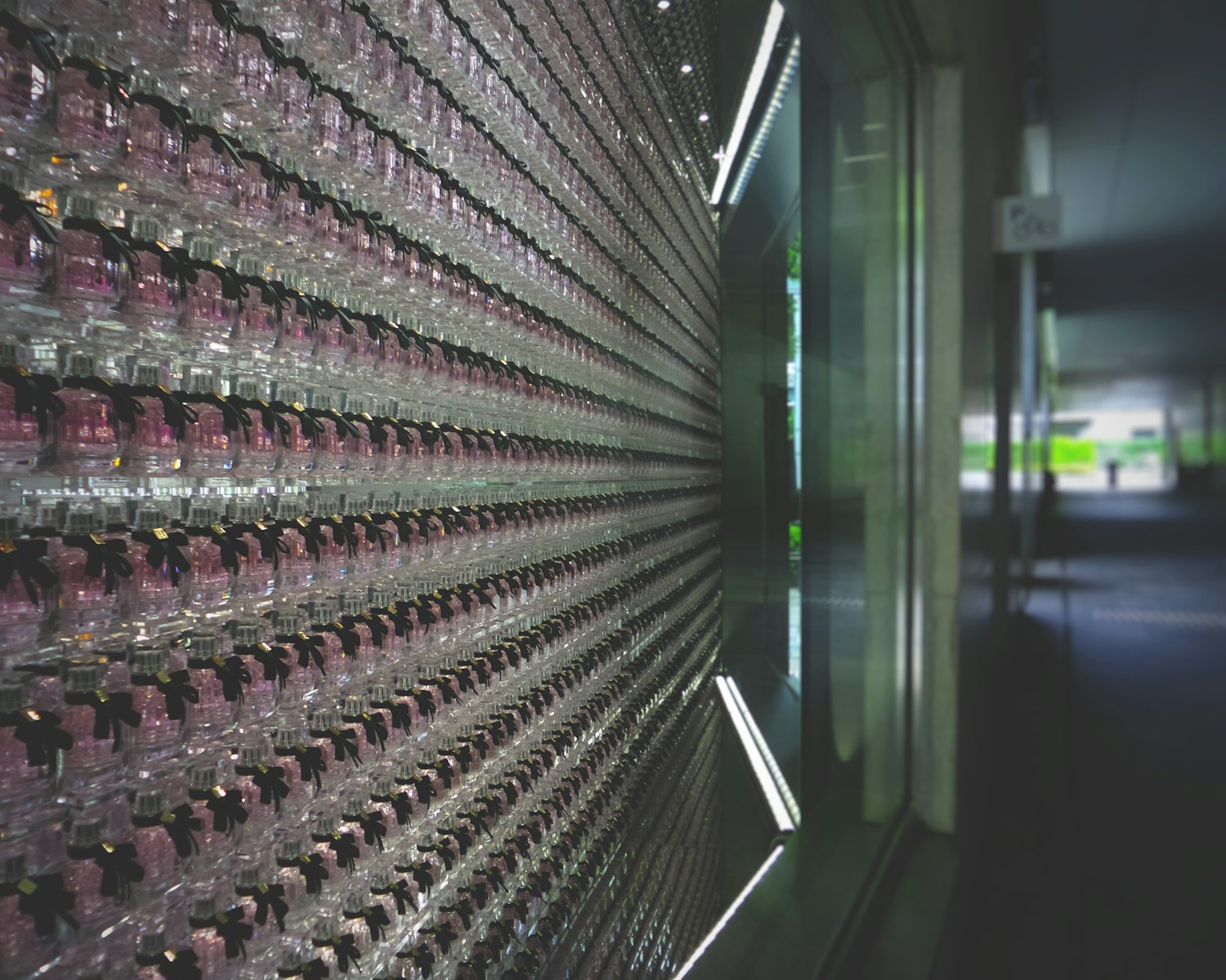 a wall of empty wine glasses in a room