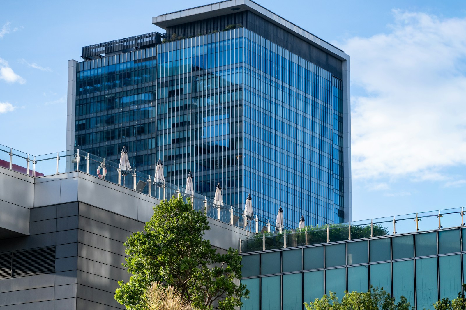 Modern glass office building with blue sky