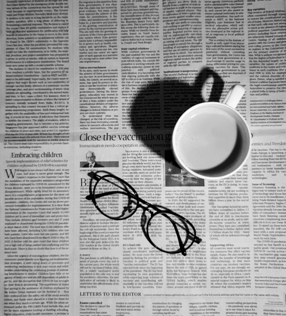 When “Letters to the Editor” Meet New AI a cup of coffee and a pair of glasses on a newspaper