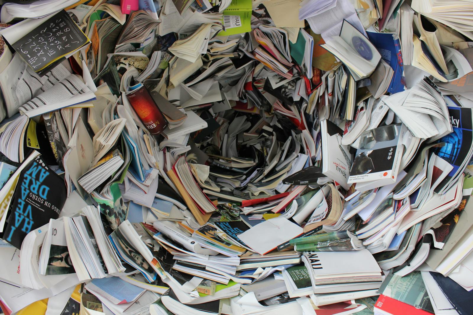AI Research Is Drowning in New Low-Quality Papers A whirlwind of books and papers creating a chaotic visual. Ideal for concepts of disorder or information overload.