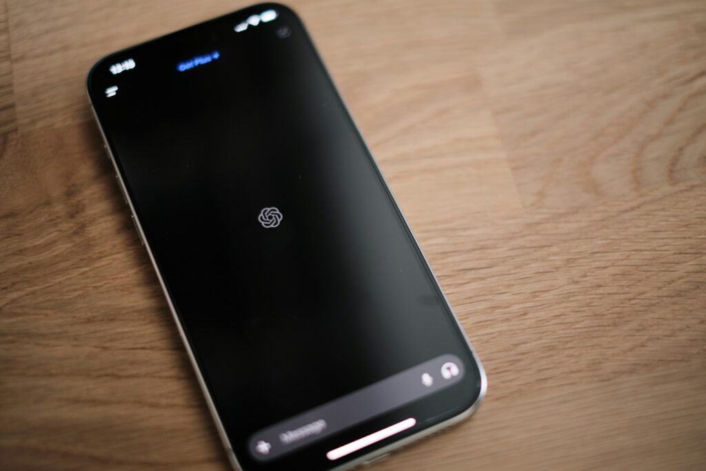 AI Is Giving New Workers an Hour Back Every Day A cell phone sitting on top of a wooden table