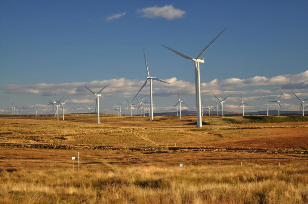 Britain Green Energy Revolution and Now Its Grid Is Paying the Price Wind farm in Eaglesham, Scotland showcasing renewable energy and sustainability.