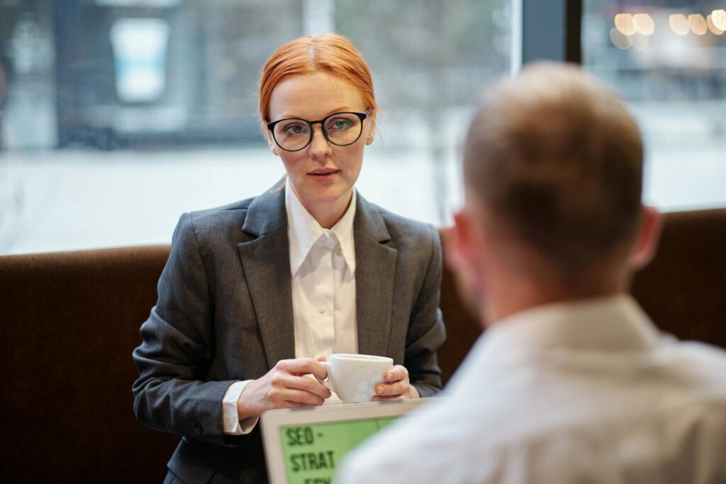 Businesswoman having a corporate meeting with coffee in a casual setting.
