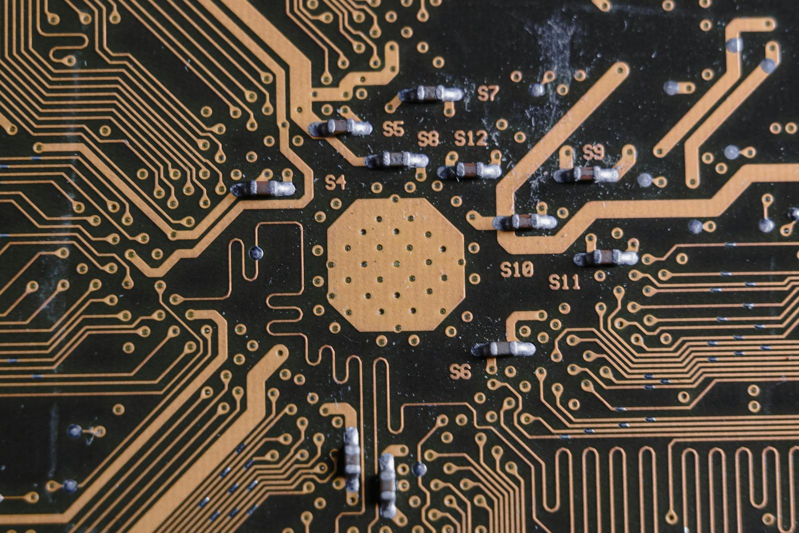 The Hidden Problem Behind the New Trillion-Dollar AI Buildout Detailed image of a printed circuit board highlighting electronic pathways and components.