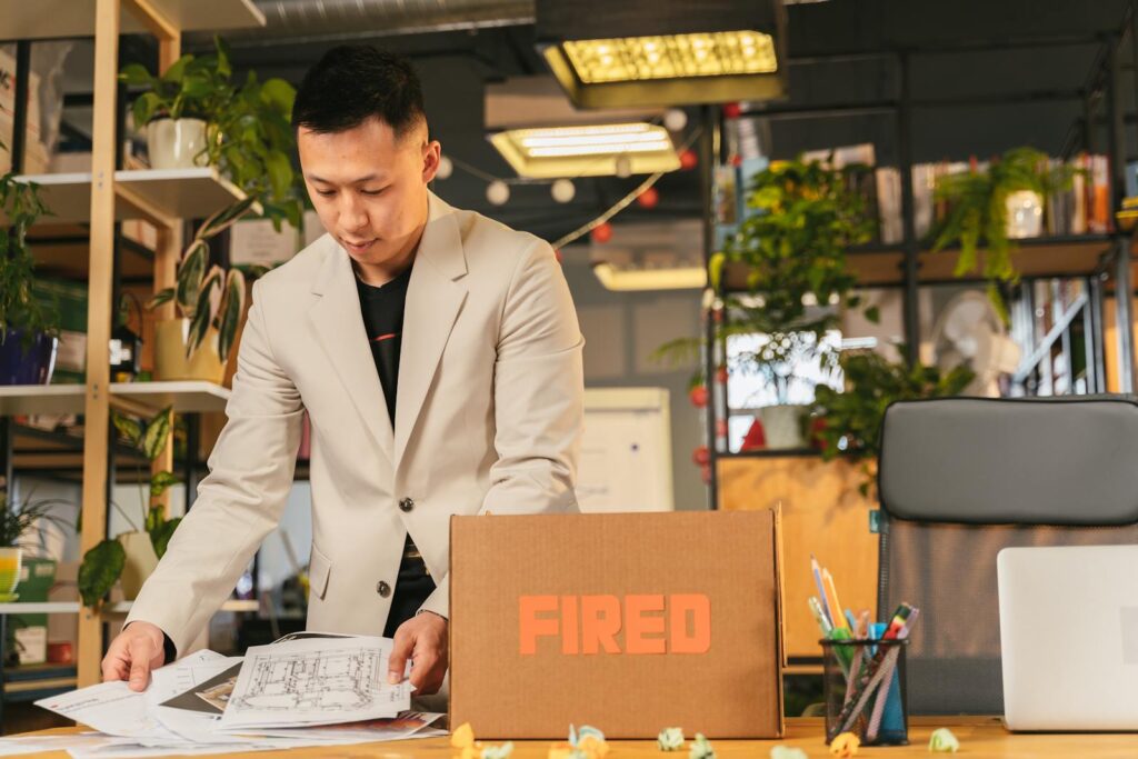 An employee packing documents into a box labeled 