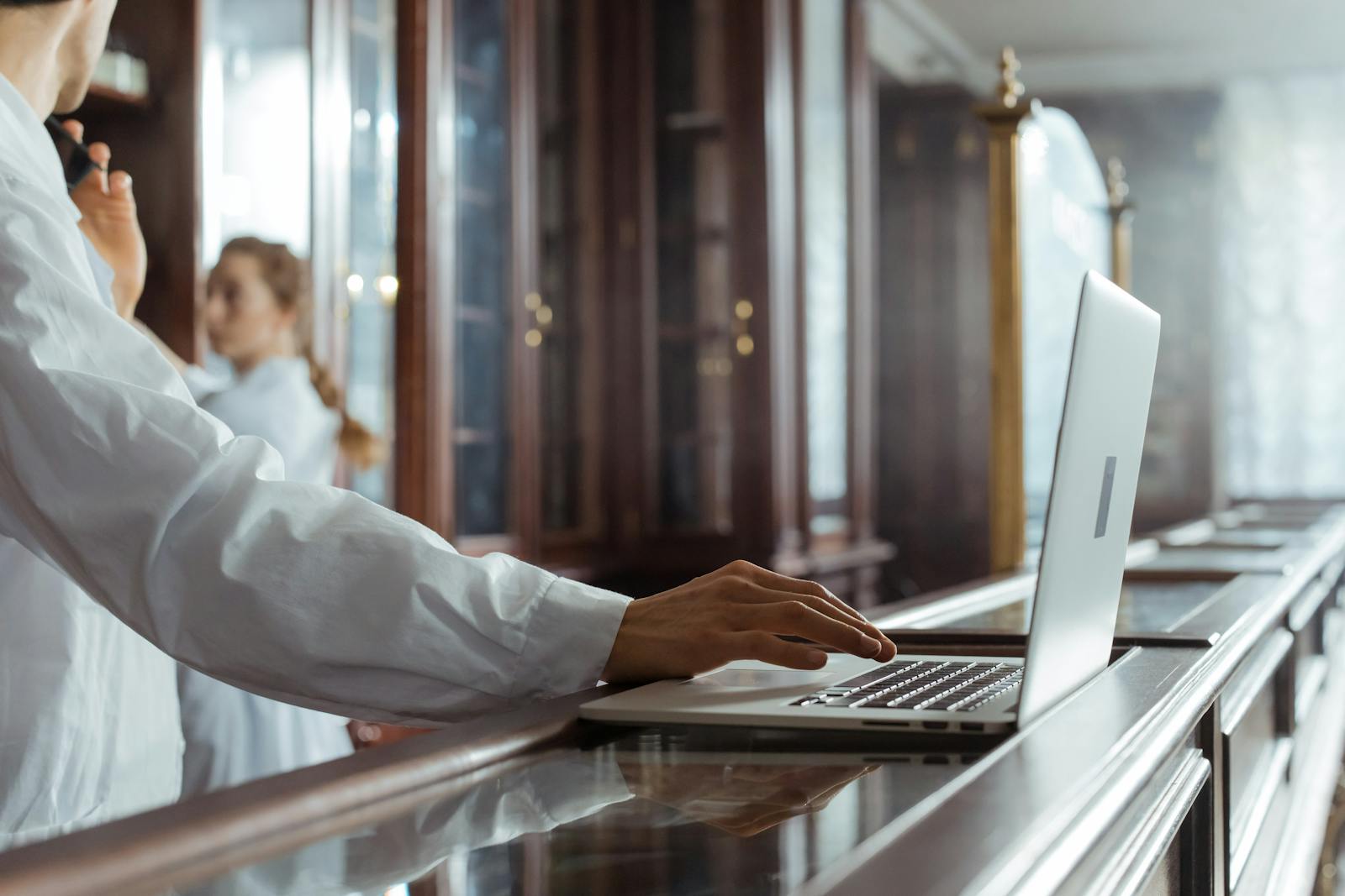 Scientist using a laptop in a laboratory, highlighting research and technology integration.