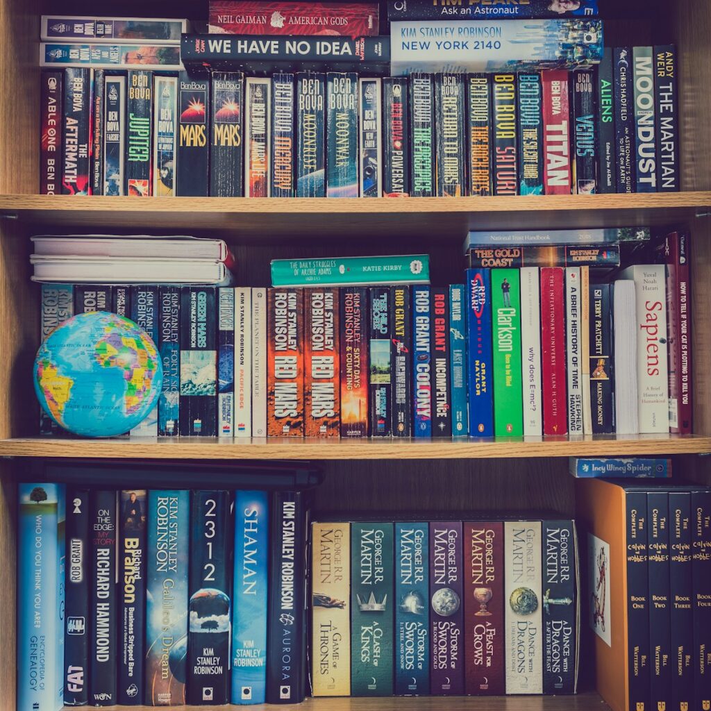books on brown wooden shelf