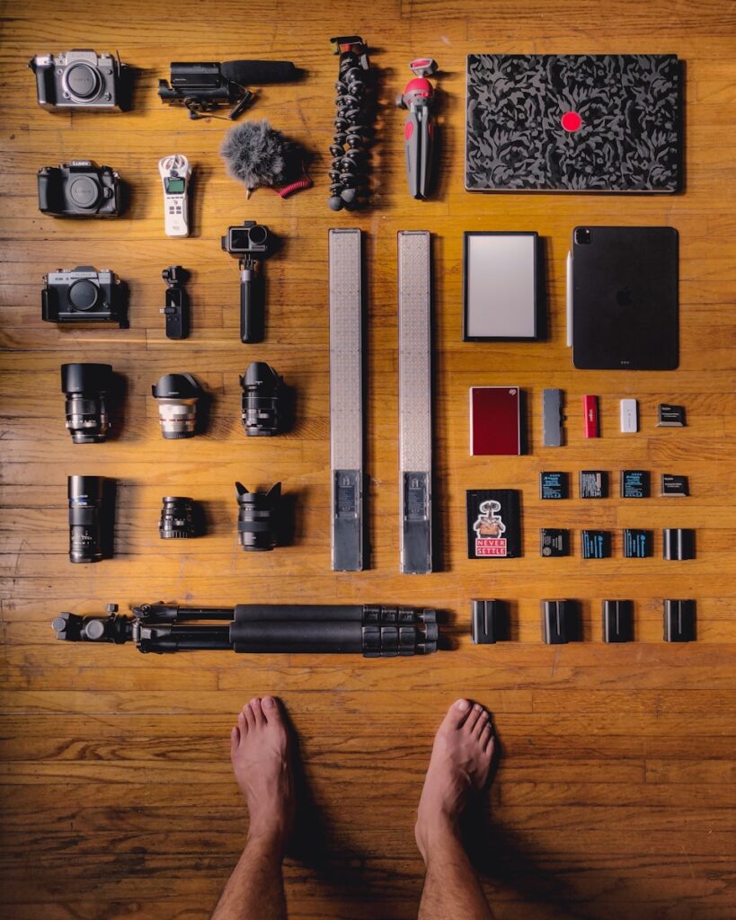 black and silver dslr camera on brown wooden table
