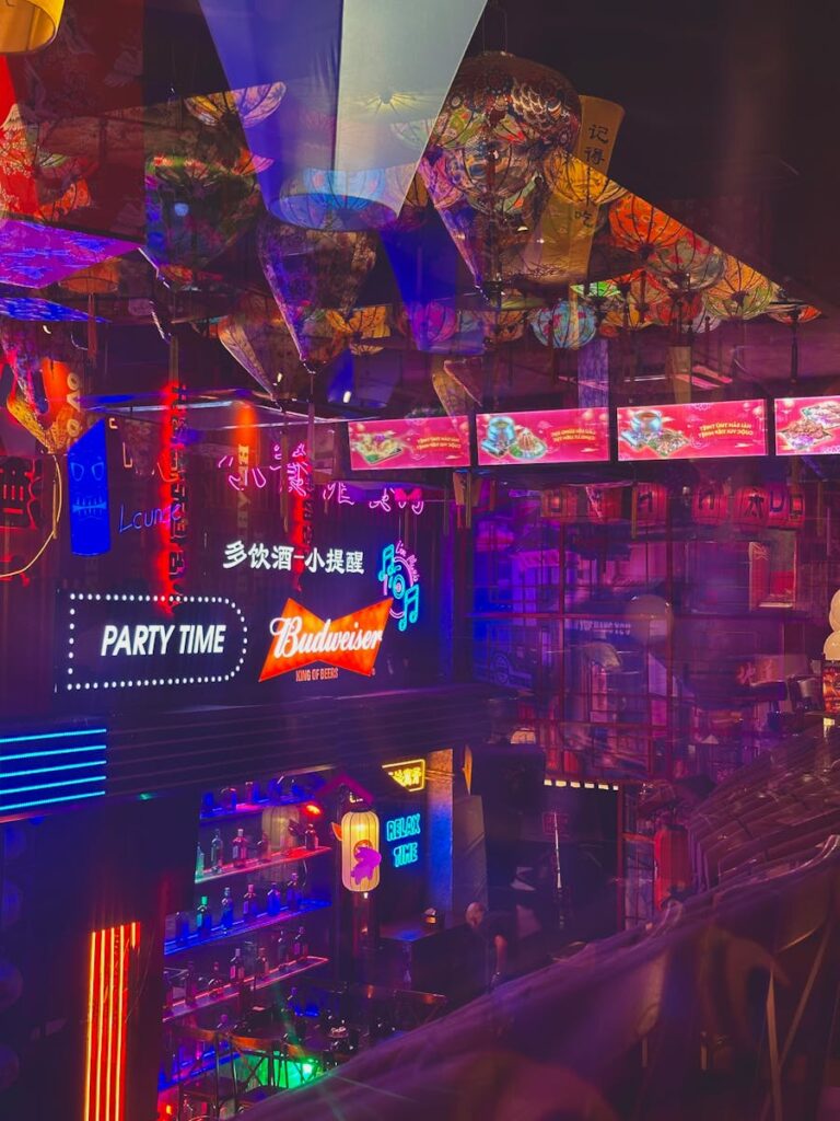 When the AI Bubble Bursts What Will Left Still Something Better Colorful neon signs illuminate a trendy bar, highlighting a lively nightlife scene.