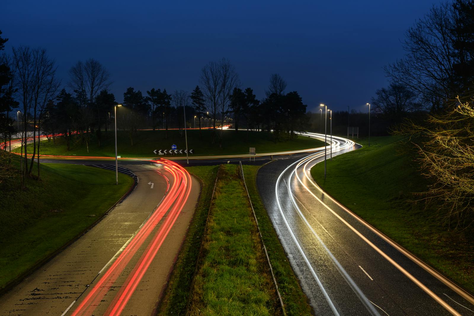 Long exposure of vehicle light trails on a roundabout in Craigavon, UK, at night.