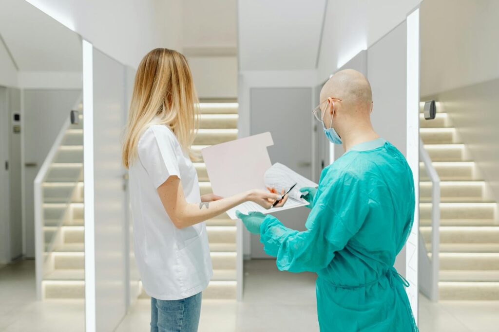 When AI Enters Healthcare, the Poor Pay the Highest Price Doctors collaborating in a bright clinic, highlighting teamwork and healthcare.